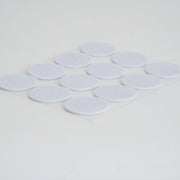 A strip of 12 Microppose 1" adherable tub filters