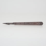 A Swann Morton number 3 scalpel on a white background